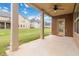 Covered patio featuring support columns, ceiling fan, and view of the lawn at 651 Deer Springs Way, Loganville, GA 30052