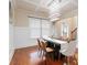 Formal dining room with modern chandelier, wainscoting, and hardwood floors, perfect for entertaining at 651 Deer Springs Way, Loganville, GA 30052