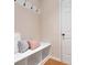 Mudroom entryway with a built-in bench, storage cubbies, hooks, and a door leading to the outside at 651 Deer Springs Way, Loganville, GA 30052