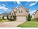 Beautiful two-story home with a two-car garage, well-maintained lawn, and a serene neighborhood setting at 651 Deer Springs Way, Loganville, GA 30052