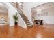 Spacious foyer with hardwood floors, staircase, and an open view of the dining room with chandelier at 651 Deer Springs Way, Loganville, GA 30052