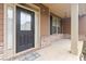 Welcoming front porch with a stylish black door, brick accents, and a cozy outdoor seating area at 651 Deer Springs Way, Loganville, GA 30052