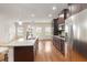 Spacious kitchen featuring a large island with granite countertops, stainless appliances, and dark cabinets at 651 Deer Springs Way, Loganville, GA 30052