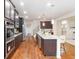 Spacious kitchen featuring stainless steel appliances, dark cabinets, and a large island with seating at 651 Deer Springs Way, Loganville, GA 30052