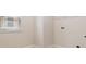 Bright laundry room with window and tiled flooring at 651 Deer Springs Way, Loganville, GA 30052
