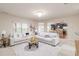 Bright living room with open layout, plush white sofas, and a view into the kitchen at 651 Deer Springs Way, Loganville, GA 30052