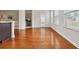 Bright and airy living space featuring beautiful hardwood floors and natural light from the adjacent windows at 651 Deer Springs Way, Loganville, GA 30052