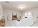 Cozy living room with a stone fireplace, neutral decor, and plush seating for relaxation at 651 Deer Springs Way, Loganville, GA 30052