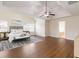 Spacious main bedroom featuring hardwood floors, a ceiling fan, tray ceilings, and large windows at 651 Deer Springs Way, Loganville, GA 30052