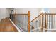 Upstairs landing with hardwood flooring and wood-metal balusters at 651 Deer Springs Way, Loganville, GA 30052