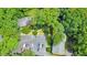 Aerial view of a brick building with mature trees and parking lot with multiple cars and surrounding greenery at 1111 Clairemont Ave # N3, Decatur, GA 30030