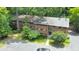 Three-story brick building with mature trees, a parking lot, and beautifully maintained green spaces at 1111 Clairemont Ave # N3, Decatur, GA 30030