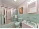 A retro-styled bathroom featuring green tile, classic fixtures, and a tub with sliding glass doors at 1111 Clairemont Ave # N3, Decatur, GA 30030