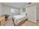 Bright bedroom featuring hardwood floors, a comfortable bed, a plant, and a window at 1111 Clairemont Ave # N3, Decatur, GA 30030