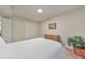 A cozy bedroom with white bedding, light colored walls, and light hardwood style floors at 1111 Clairemont Ave # N3, Decatur, GA 30030