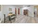 Dining area featuring hardwood floors, table with seating, bookshelf, and view to the entry hall at 1111 Clairemont Ave # N3, Decatur, GA 30030