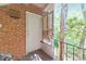 Exterior entryway with a metal railing, brick walls, and a white door with a screen, with wooded views at 1111 Clairemont Ave # N3, Decatur, GA 30030