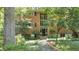 Traditional red brick building with black shutters and large windows surrounded by mature trees at 1111 Clairemont Ave # N3, Decatur, GA 30030