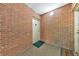 Interior hallway with brick walls and textured flooring at 1111 Clairemont Ave # N3, Decatur, GA 30030