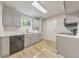 Bright kitchen featuring stainless steel dishwasher, light wood floors, and white marble countertops at 1111 Clairemont Ave # N3, Decatur, GA 30030