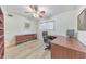 Bright office space featuring modern desk, chair, and ample storage with wood-look floors and a ceiling fan at 1111 Clairemont Ave # N3, Decatur, GA 30030
