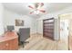 Bright office space featuring modern desk, chair, and ample storage with wood-look floors and a ceiling fan at 1111 Clairemont Ave # N3, Decatur, GA 30030