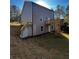 Back of a two-story house with gray siding, deck, walkout basement, and sloped backyard at 192 Paces Lakes Pt, Dallas, GA 30157