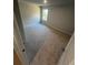 Bright bedroom featuring neutral walls, plush carpeting, and a window providing plenty of natural light at 192 Paces Lakes Pt, Dallas, GA 30157