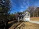 Two-story home featuring a gray facade, attached garage, and a long driveway with wooded surroundings at 192 Paces Lakes Pt, Dallas, GA 30157