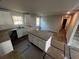 Unfinished kitchen features white cabinets, granite countertops, an island, and stainless steel sink at 192 Paces Lakes Pt, Dallas, GA 30157