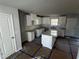 Unfinished kitchen features white cabinets, granite countertops, and an island ready for customization at 192 Paces Lakes Pt, Dallas, GA 30157