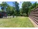 Lush green backyard with a fire pit area and multi-level deck, perfect for outdoor entertaining at 429 Oakland Ave, Atlanta, GA 30312