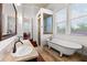 Bright bathroom featuring a soaking tub, glass shower, double vanity sinks, and a charming interior design at 429 Oakland Ave, Atlanta, GA 30312