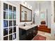 Bathroom showcasing double sinks with a vanity, with a clear view into the walk-in closet at 429 Oakland Ave, Atlanta, GA 30312