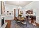 Bright dining room with hardwood floors, fireplace and chandelier, flowing into the kitchen at 429 Oakland Ave, Atlanta, GA 30312