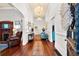 Welcoming hallway with wood floors, chandeliers, and a view of the fireplace at 429 Oakland Ave, Atlanta, GA 30312