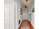Inviting hallway with wooden floors, a decorative rug, and sunlight streaming through a stained glass window at 429 Oakland Ave, Atlanta, GA 30312