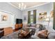 Inviting living room with a comfortable sectional, wood floors, and large windows at 429 Oakland Ave, Atlanta, GA 30312
