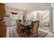 Elegant dining room featuring a large wooden table, chandelier, and staircase view at 2525 Highbrooke Trl, Duluth, GA 30097