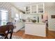 Bright kitchen featuring white cabinets, a functional island, and an adjacent laundry area, perfect for convenience at 2525 Highbrooke Trl, Duluth, GA 30097