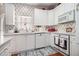 Charming kitchen with white cabinetry, modern appliances, and a cozy atmosphere for cooking and dining at 2525 Highbrooke Trl, Duluth, GA 30097