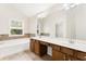 Main bath with double sinks, bath tub, and window overlooking outside at 2957 Smith Ridge Trce, Peachtree Corners, GA 30071