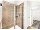 Tiled walk in shower with glass doors leading to walk-in closet and bathroom area at 2957 Smith Ridge Trce, Peachtree Corners, GA 30071