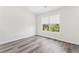 Neutral bedroom with hard wood floors and one large window at 2957 Smith Ridge Trce, Peachtree Corners, GA 30071