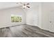 Large bedroom with light colored floors, vaulted ceilings, ceiling fan, and large window overlooking outside at 2957 Smith Ridge Trce, Peachtree Corners, GA 30071