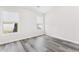 Bedroom features modern gray wood floors and two bright windows at 2957 Smith Ridge Trce, Peachtree Corners, GA 30071