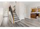 Bright foyer with hardwood floors, staircase, and an open view to the kitchen at 2957 Smith Ridge Trce, Peachtree Corners, GA 30071