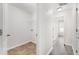 Hallway with Laundry Room and light-toned Hard Wood Flooring at 2957 Smith Ridge Trce, Peachtree Corners, GA 30071