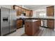 Open kitchen with stainless steel refrigerator, appliances, granite countertops, and light colored floors at 2957 Smith Ridge Trce, Peachtree Corners, GA 30071
