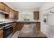 Spacious kitchen with granite countertops, island, stainless steel appliances, and light colored floors at 2957 Smith Ridge Trce, Peachtree Corners, GA 30071